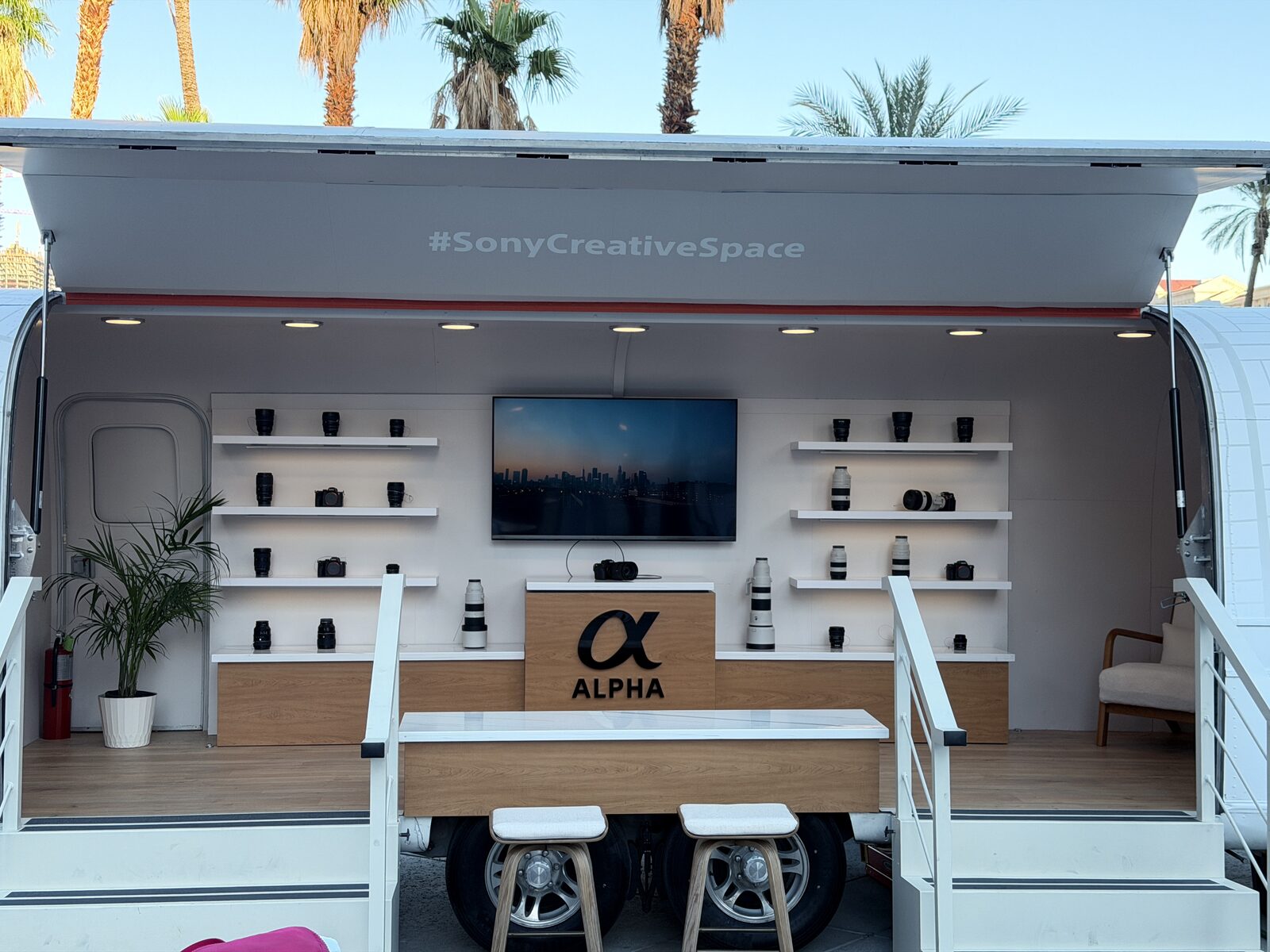 Outdoor tour print trailer set up as a live merch station at a festival